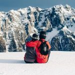 Romantic couple in a shikara on Dal Lake in Kashmir, surrounded by majestic mountains and lush greenery