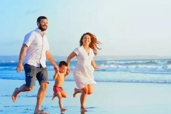 Indian family walking along Radhanagar Beach in Havelock during a peaceful Andaman trip covering Neil Island and Port Blair.